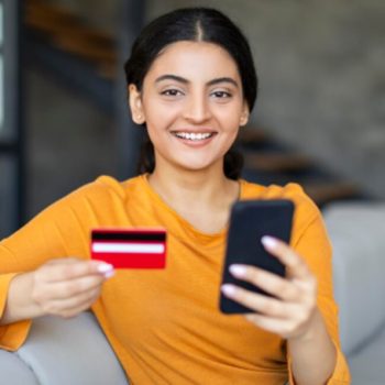 A woman checking her EMI card status online via phone.