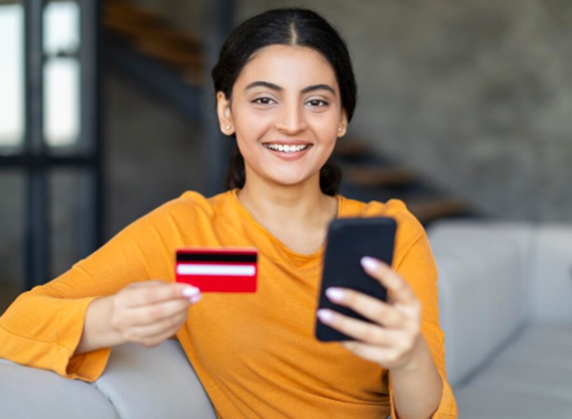 A woman checking her EMI card status online via phone.